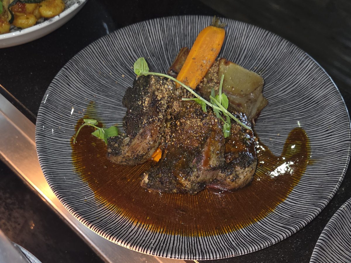 Braised beef with jus, glazed carrot and fondant potato, plated on the pass